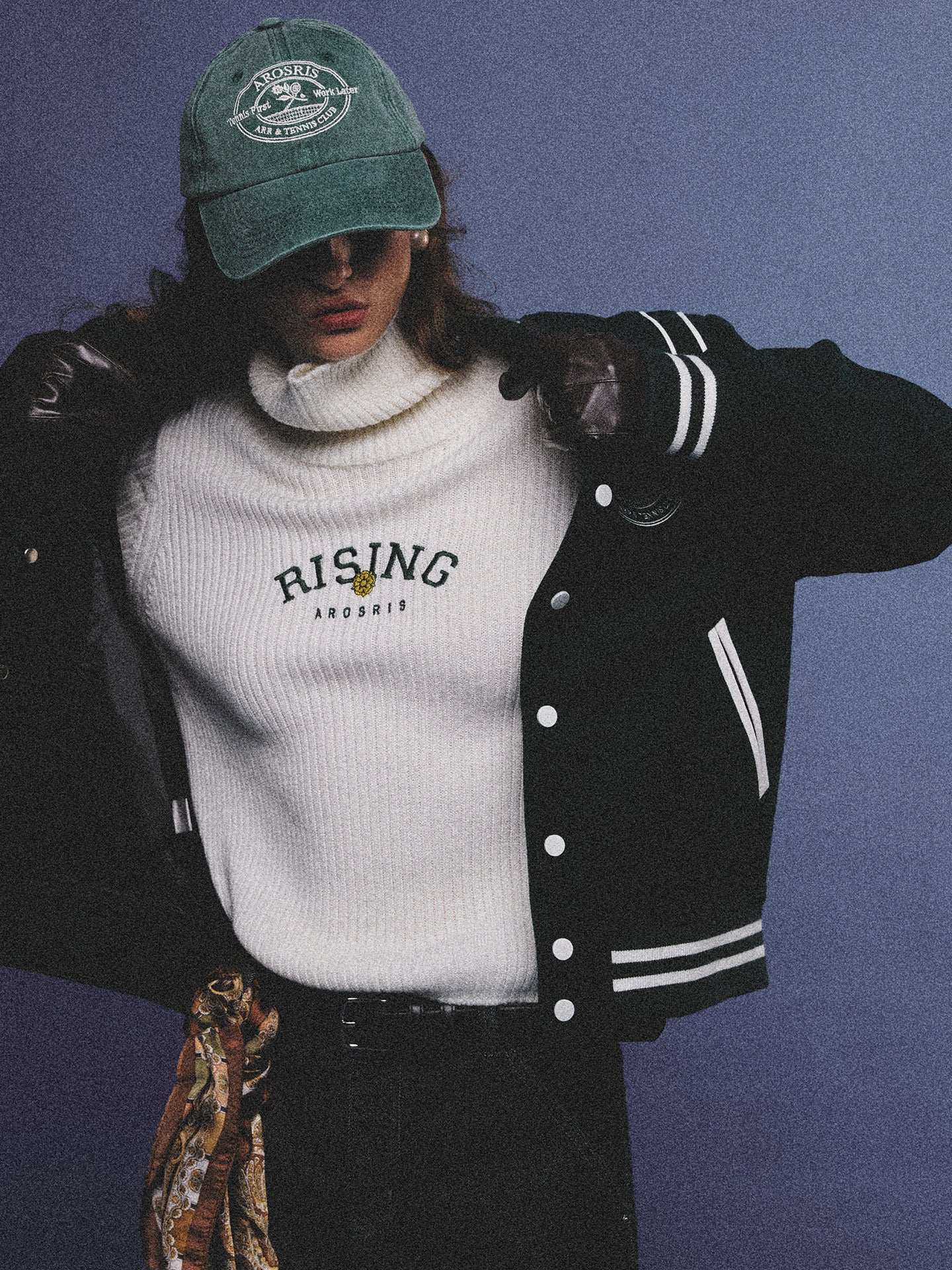 Arosris classic modern white ribbed wool blend turtleneck featuring a vintage 'RISING' floral embroidery, elegantly styled on a model as an effortless 90s preppy foundational layering piece.
