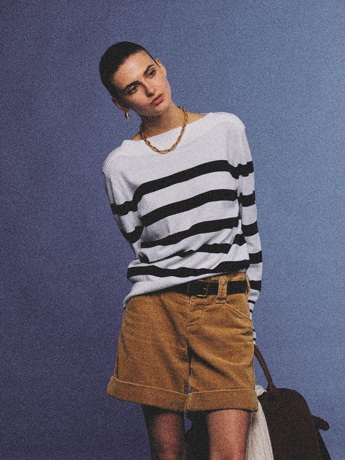 Arosris Riviera navy striped boat neck sweater elegantly styled on a model with corduroy shorts and vintage accessories, capturing an effortless 90s old money coastal resort aesthetic.