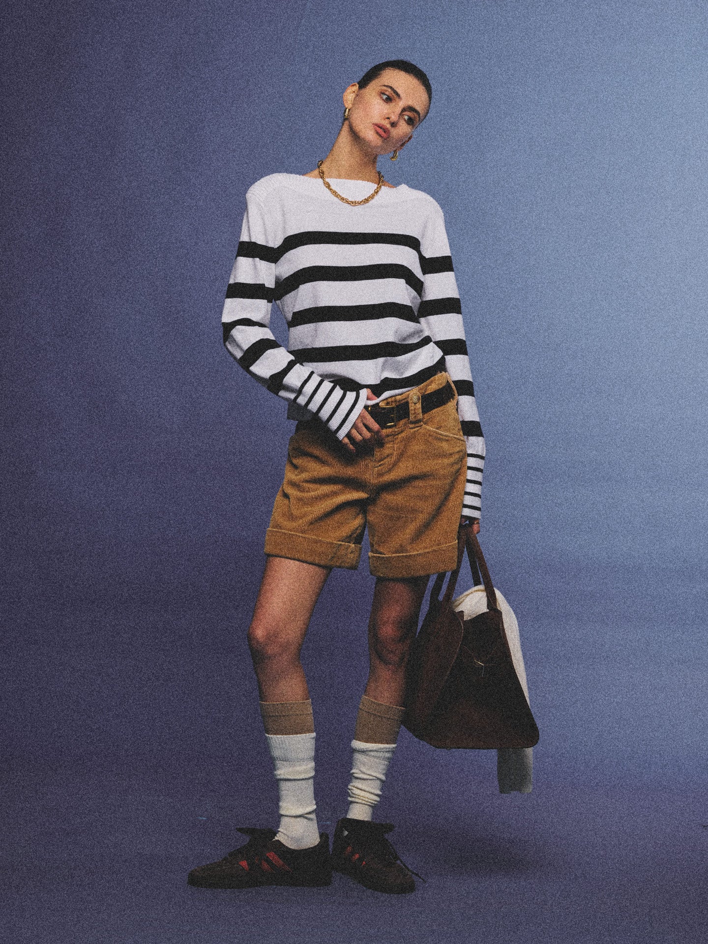 Arosris Riviera navy striped boat neck sweater elegantly styled on a model with corduroy shorts and vintage accessories, capturing an effortless 90s old money coastal resort aesthetic.