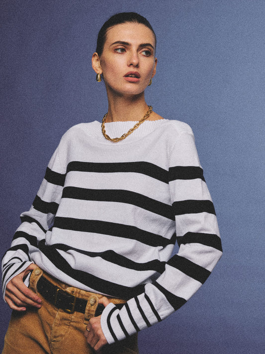 Arosris Riviera navy striped boat neck sweater elegantly styled on a model with corduroy shorts and vintage accessories, capturing an effortless 90s old money coastal resort aesthetic.