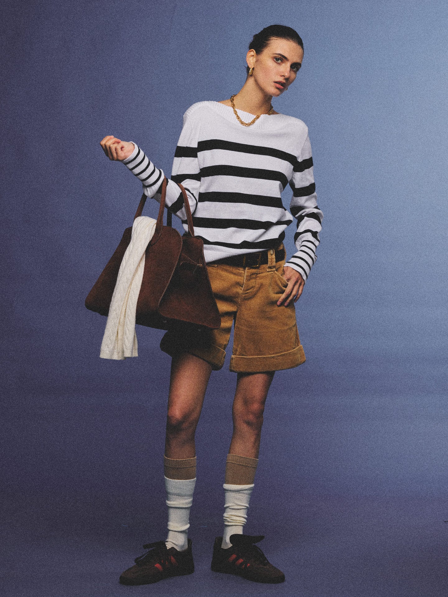 Arosris Riviera navy striped boat neck sweater elegantly styled on a model with corduroy shorts and vintage accessories, capturing an effortless 90s old money coastal resort aesthetic.