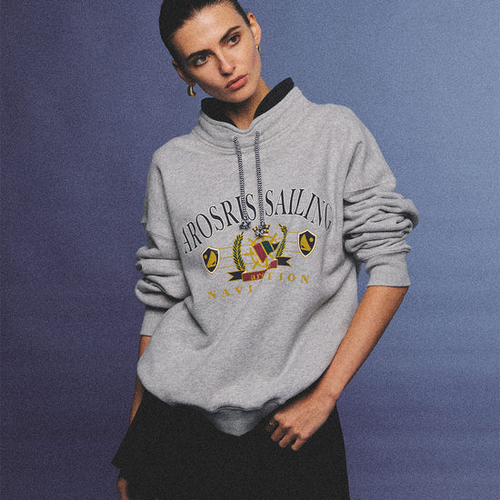 Arosris ash grey sailing navigation mock neck sweatshirt elegantly styled on a model, capturing an effortless 90s sporty-chic coastal yacht club aesthetic.