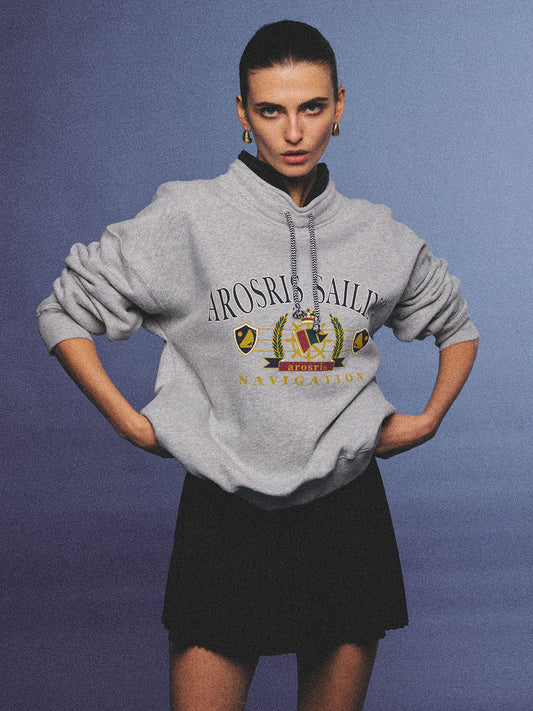 Arosris ash grey sailing navigation mock neck sweatshirt elegantly styled on a model, capturing an effortless 90s sporty-chic coastal yacht club aesthetic.