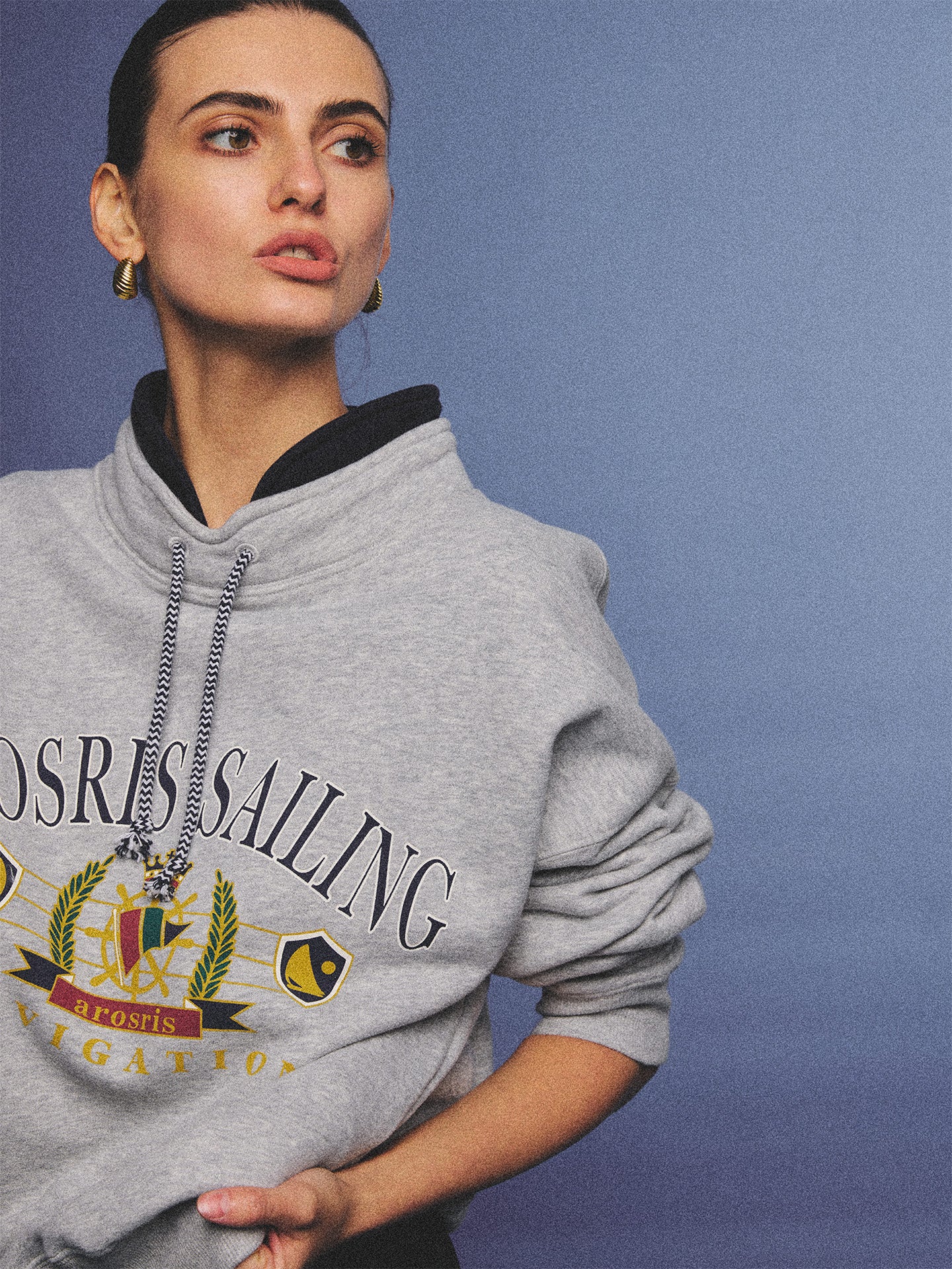 Arosris ash grey sailing navigation mock neck sweatshirt elegantly styled on a model, capturing an effortless 90s sporty-chic coastal yacht club aesthetic.