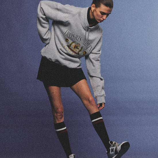 Arosris ash grey sailing navigation mock neck sweatshirt elegantly styled on a model, capturing an effortless 90s sporty-chic coastal yacht club aesthetic.