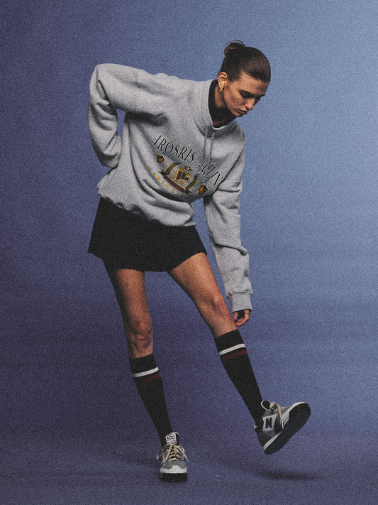 Arosris ash grey sailing navigation mock neck sweatshirt elegantly styled on a model, capturing an effortless 90s sporty-chic coastal yacht club aesthetic.
