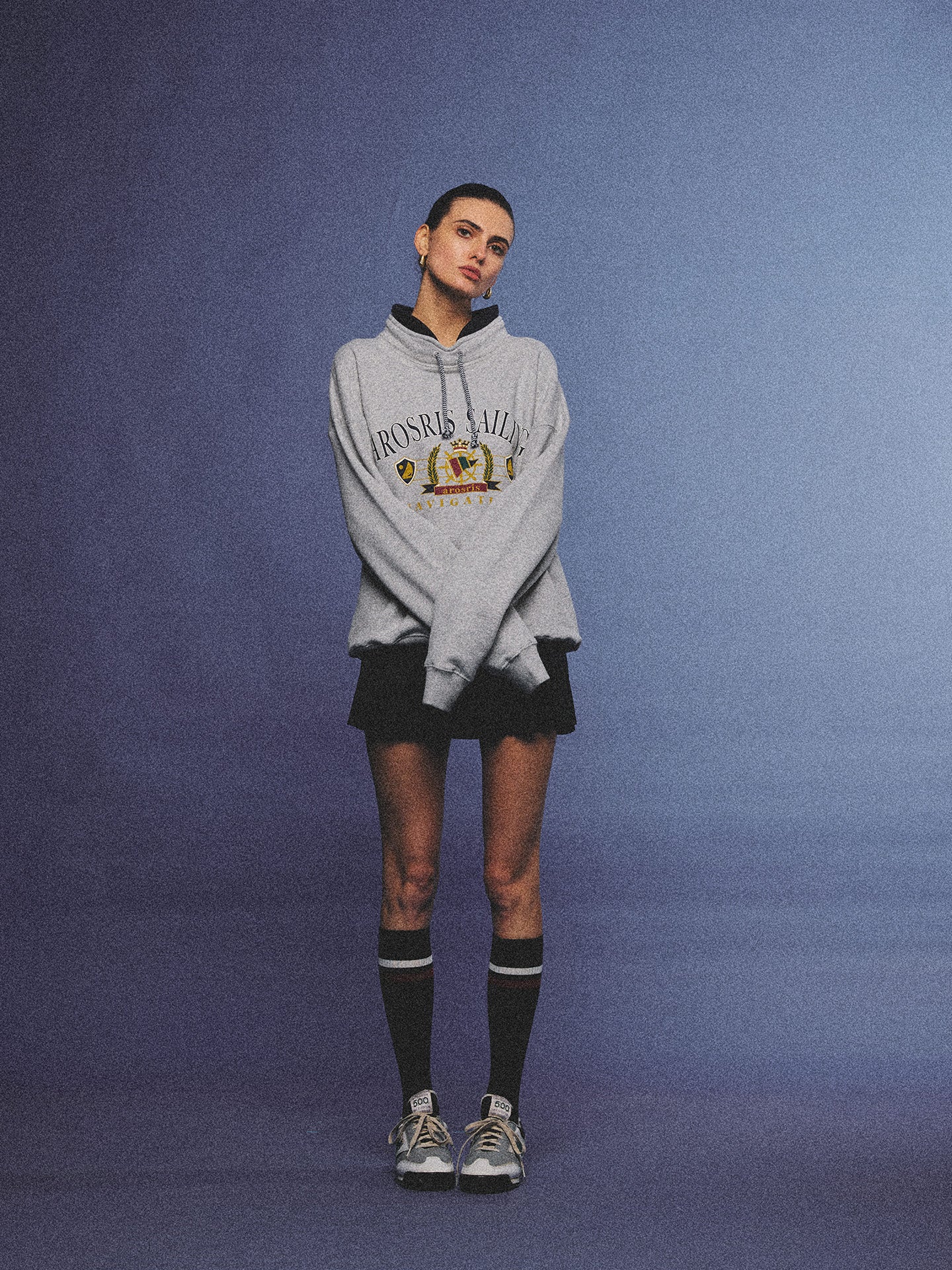 Arosris ash grey sailing navigation mock neck sweatshirt elegantly styled on a model, capturing an effortless 90s sporty-chic coastal yacht club aesthetic.