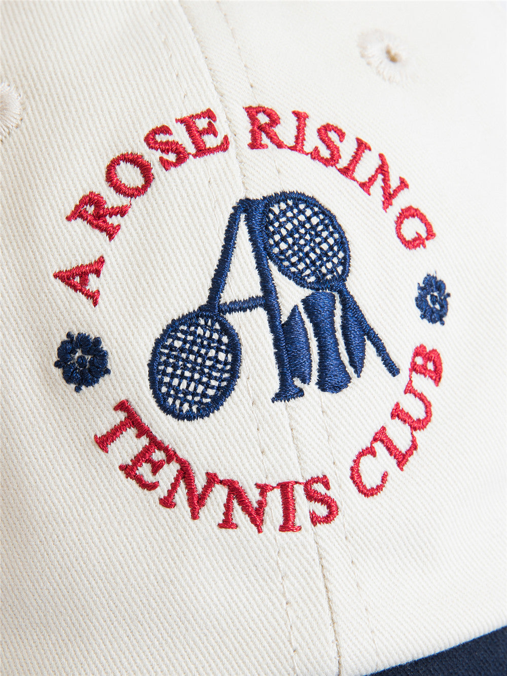 Arosris two-tone cream and navy tennis club dad hat showcasing a classic 6-panel fit, curved brim, and signature vintage crest embroidery.