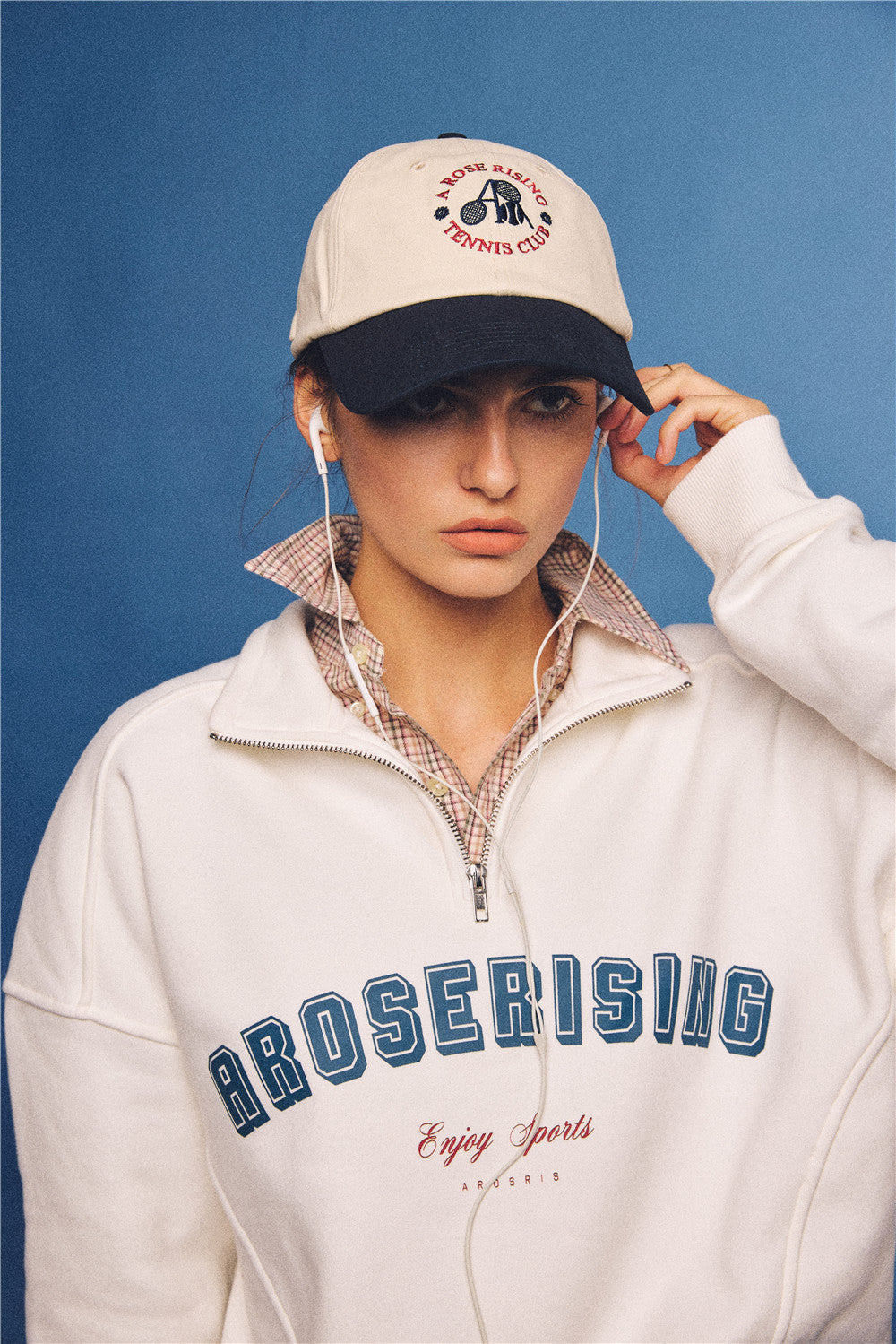 Arosris vintage-inspired two-tone cream and navy tennis club dad hat, styled with a retro half-zip sweatshirt for an effortless 90s sporty-rich aesthetic.