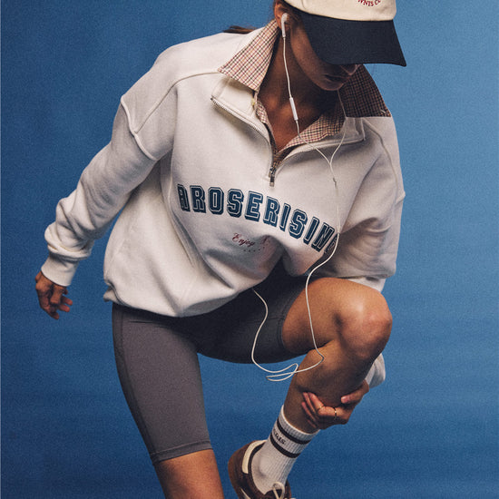 Arosris vintage-inspired two-tone cream and navy tennis club dad hat, styled with a retro half-zip sweatshirt for an effortless 90s sporty-rich aesthetic.