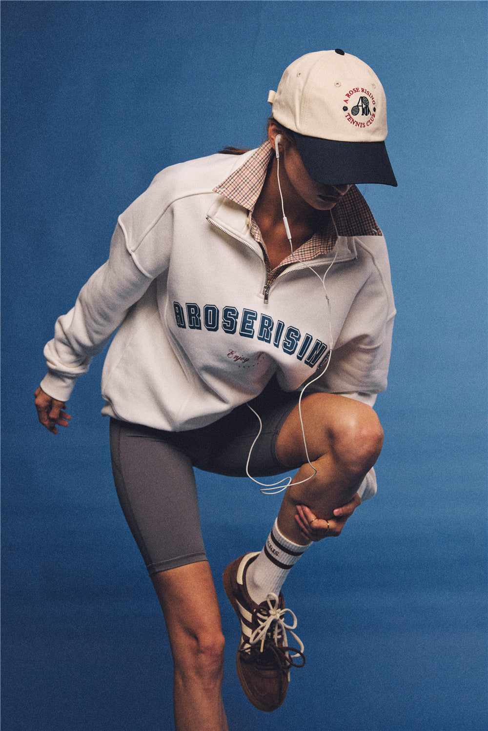 Arosris vintage-inspired two-tone cream and navy tennis club dad hat, styled with a retro half-zip sweatshirt for an effortless 90s sporty-rich aesthetic.
