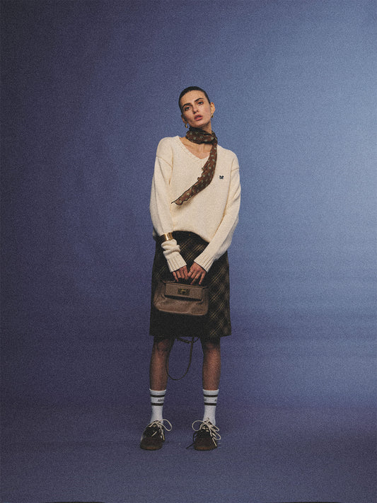 Arosris creamy khaki v-neck embroidered sweater, elegantly styled with a vintage silk scarf and plaid skirt for an effortless 90s old money aesthetic.
