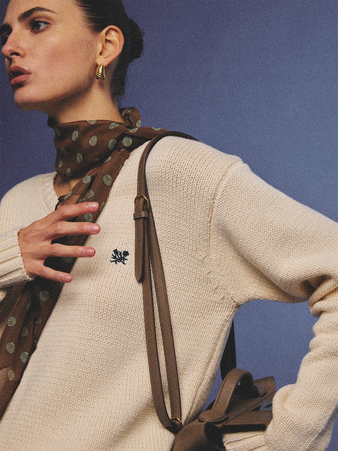 Arosris creamy khaki v-neck embroidered sweater, elegantly styled with a vintage silk scarf and plaid skirt for an effortless 90s old money aesthetic.