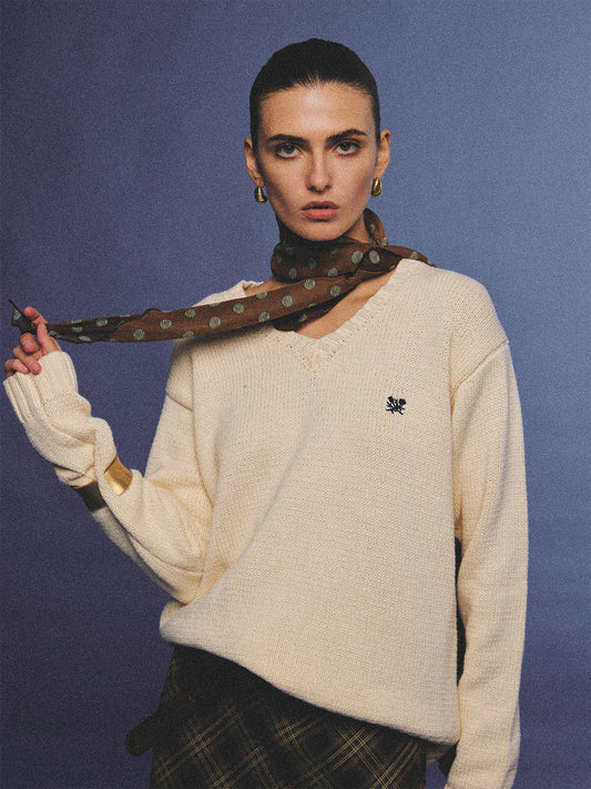 Arosris creamy khaki v-neck embroidered sweater, elegantly styled with a vintage silk scarf and plaid skirt for an effortless 90s old money aesthetic.