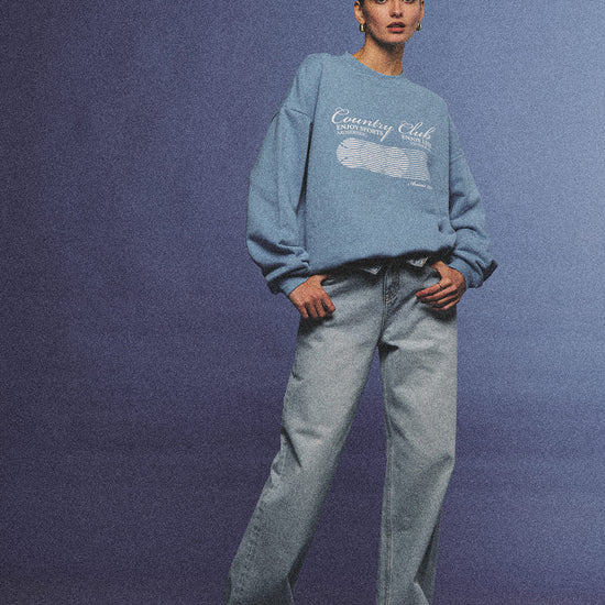 Arosris light wash high-rise wide leg denim jeans styled on a model in various poses, showcasing the structured 100% rigid cotton fit and an effortless 90s-inspired off-duty aesthetic.