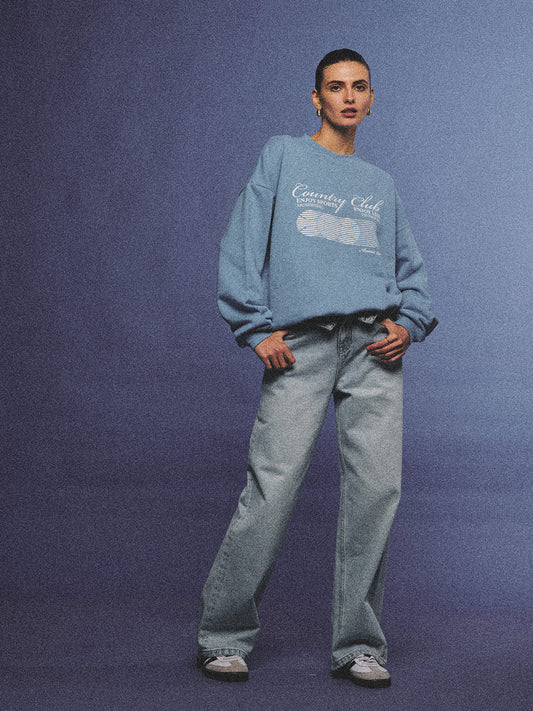 Arosris light wash high-rise wide leg denim jeans styled on a model in various poses, showcasing the structured 100% rigid cotton fit and an effortless 90s-inspired off-duty aesthetic.